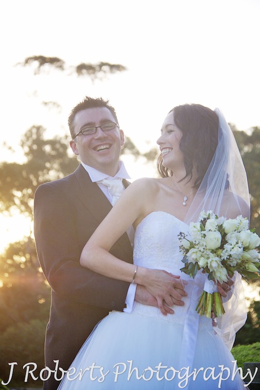 Bride and groom laughing at sunset - wedding photography sydney